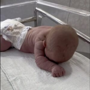 Infant crawls across hospital crib Infant crawls across hospital crib