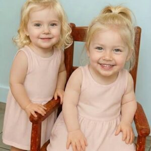 Young woman puts both babies inside the fir…